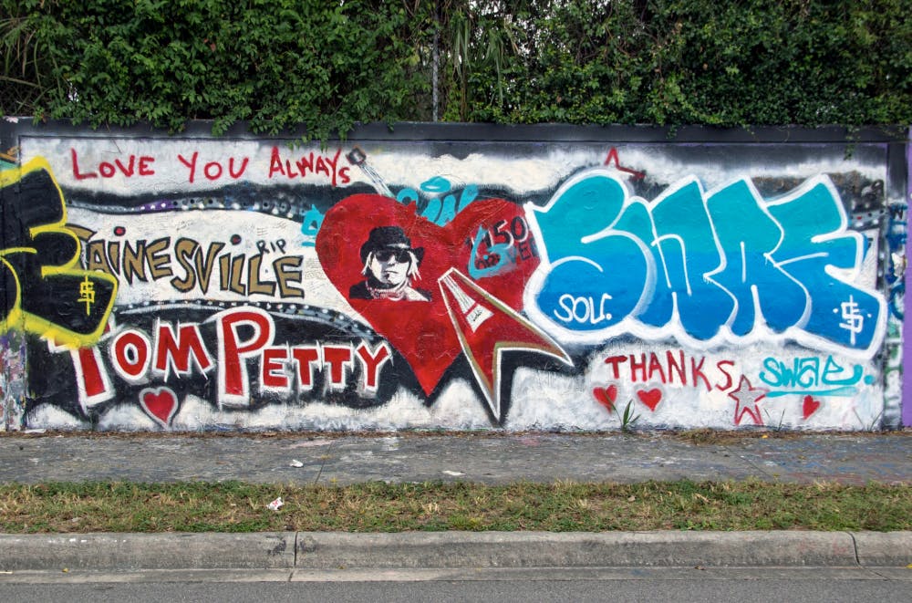 A mural dedicated to Tom Petty on the 34th Street graffiti wall was defaced Sunday with blue and white graffiti. The mural has been up since October 2017 when Petty died.