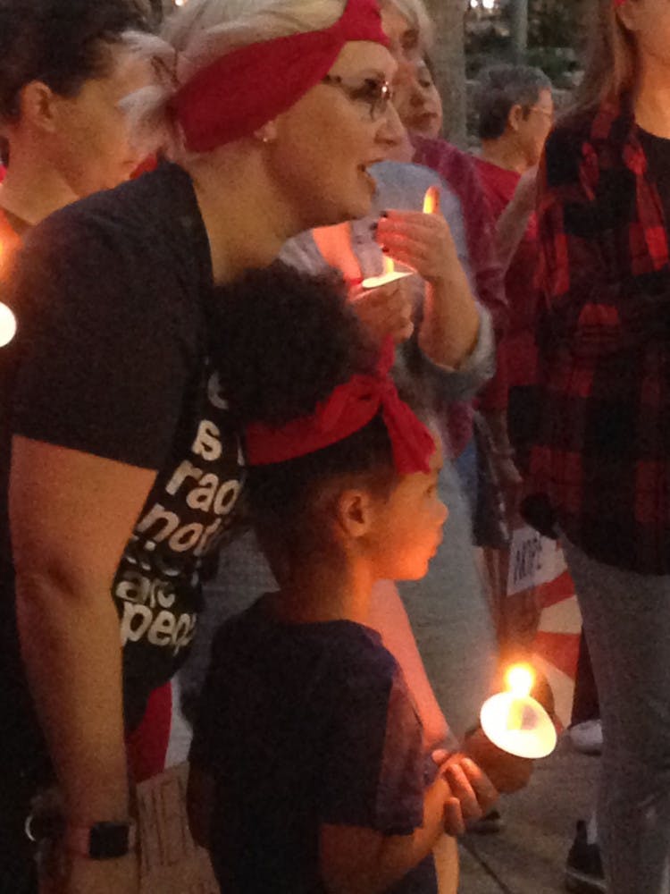 Joy Pitts, 35, brought her 5-year-old daughter, Olivia, to the candlelight vigil held Wednesday at Gainesville City Hall for International Women’s Day. “This is why I do everything I do; I do it for her,” Pitts said.