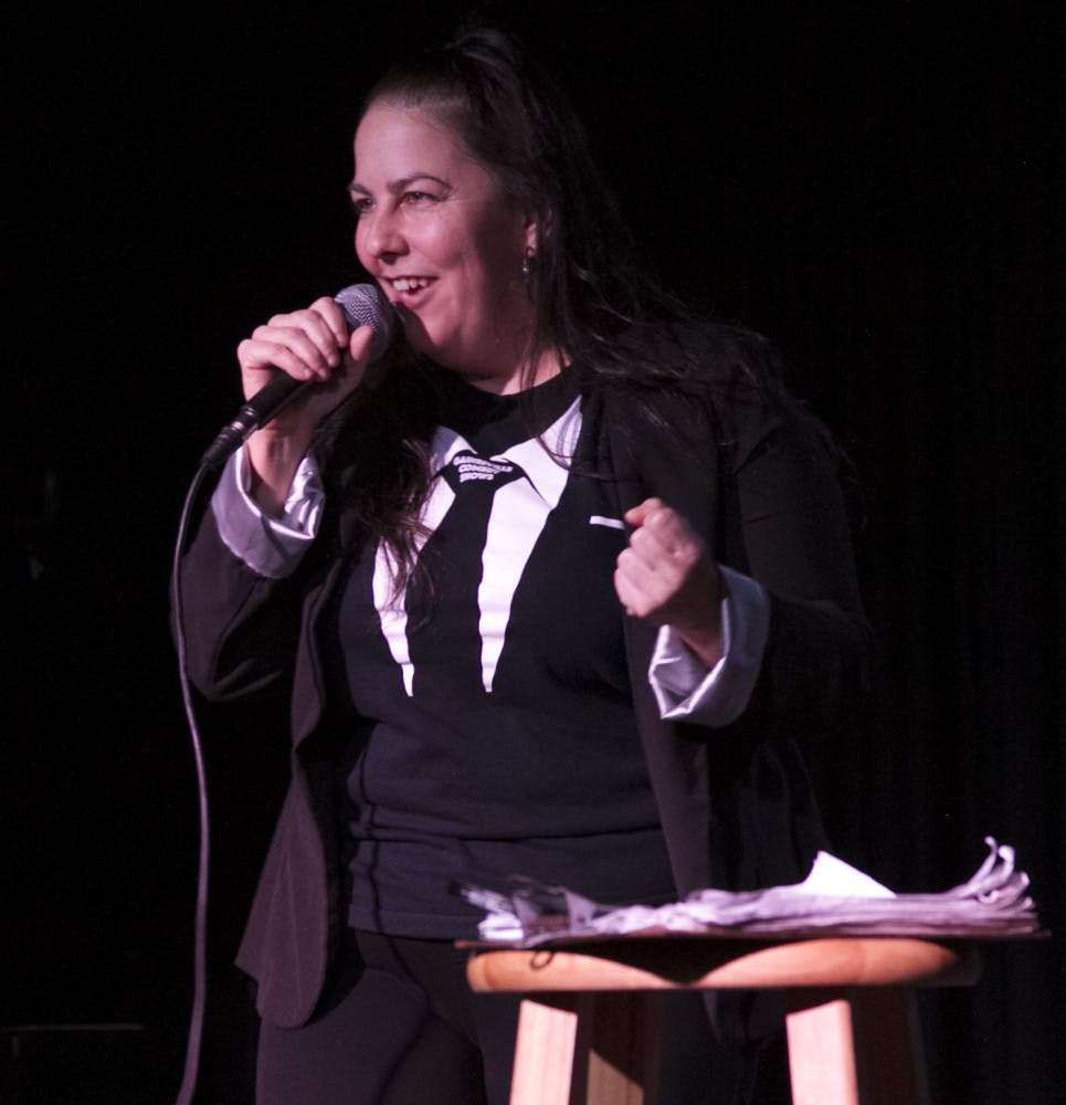Jennifer "Jenarchy" Vito introduces the next comedy act onstage.