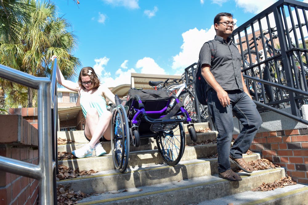 Hailey Remigio, a 19-year-old UF neuroscience sophomore, attempts to get down a set of stairs outside Rawlings Hall. “No one actually stopped and gave me a second look,” she said. “It wasn’t the slightest bit of a challenge for every passerby, but to me and other persons with disabilities, it was nearly impossible. And until you look through our eyes, you just won’t see it, not because you’re ignorant but because no one had shed light on it before.”