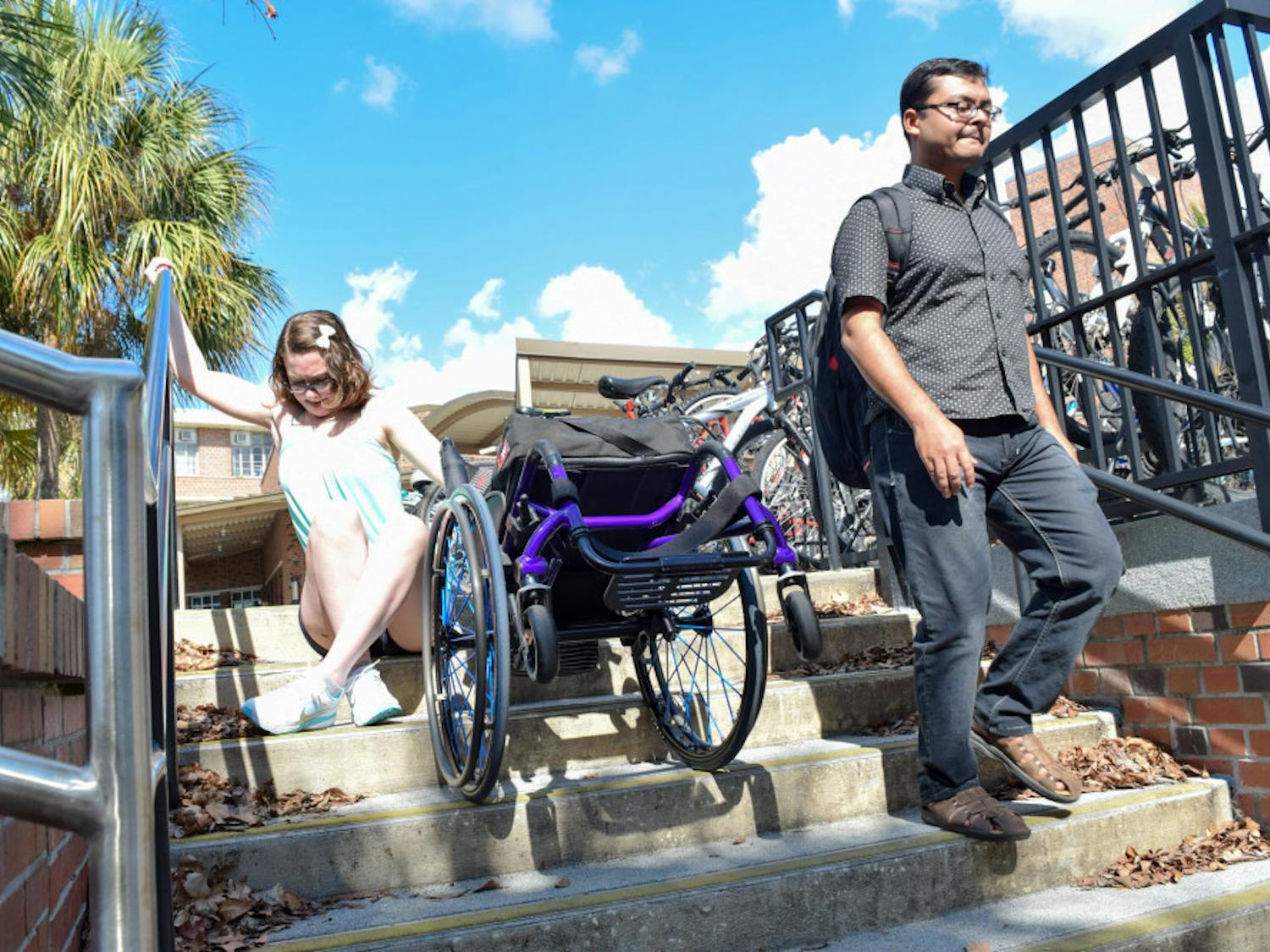 Hailey Remigio, a 19-year-old UF neuroscience sophomore, attempts to get down a set of stairs outside Rawlings Hall. “No one actually stopped and gave me a second look,” she said. “It wasn’t the slightest bit of a challenge for every passerby, but to me and other persons with disabilities, it was nearly impossible. And until you look through our eyes, you just won’t see it, not because you’re ignorant but because no one had shed light on it before.”