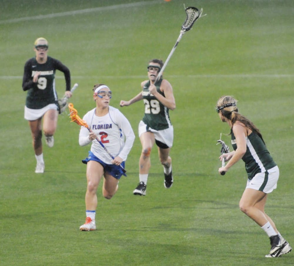 <p>Sammi Burgess (2) drives to the net during Florida’s 21-5 win against Jacksonville on Feb. 12 at Donald R. Dizney Stadium. Burgess chose UF over several different schools.</p>