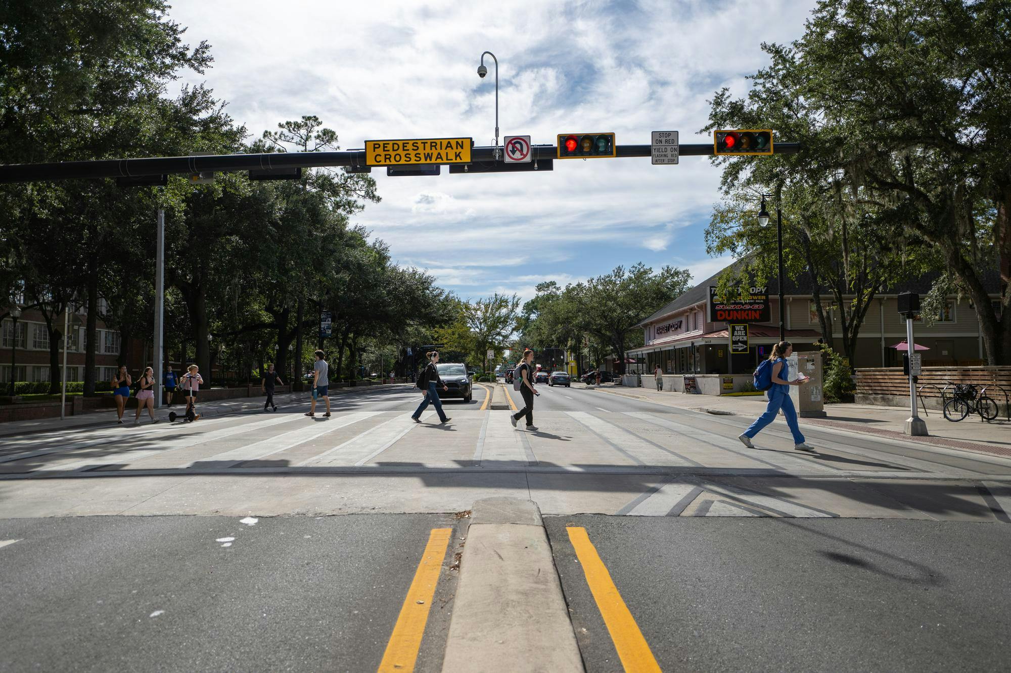 Pedestrians cross University Blvd. at a raised crosswalk on Wednesday, Sept. 3, 2025, in Gainesville, Fla.