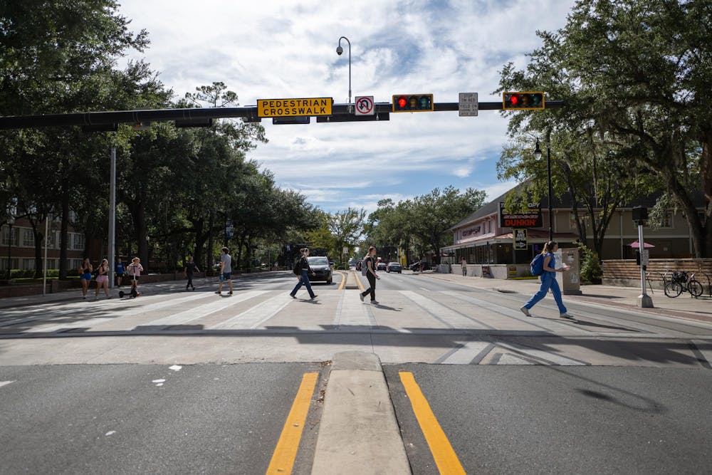 Pedestrians cross University Blvd. at a raised crosswalk on Wednesday, Sept. 3, 2025, in Gainesville, Fla.