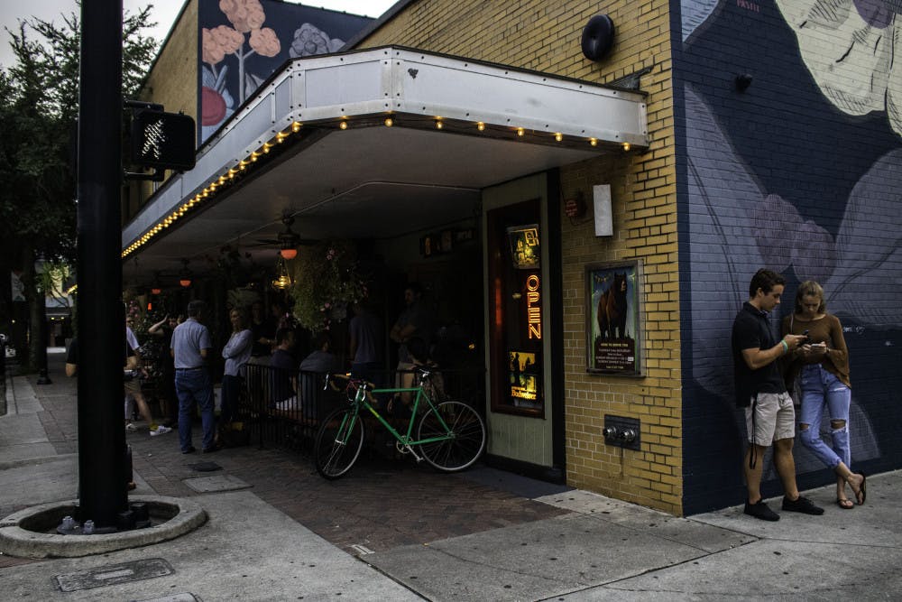Customers of The Top, located at 30 N. Main St., stand outside and wait to be seated Wednesday night.