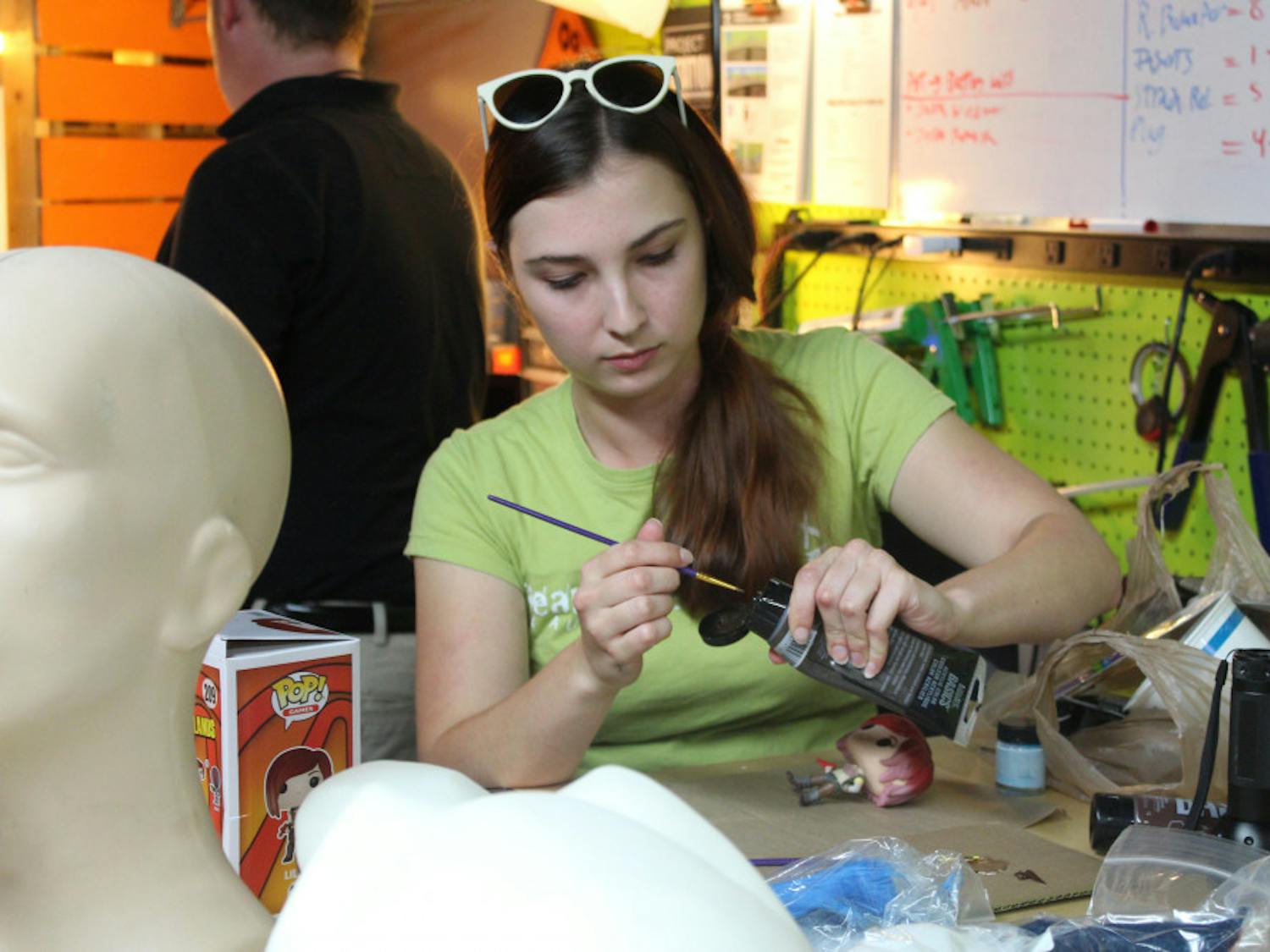 Jessica Hvozdovich, 24, repaints a figurine of Lilith from the video game "Borderlands 2." She was one of about 15 people who attended a cosplay workshop event at Hackerspace.