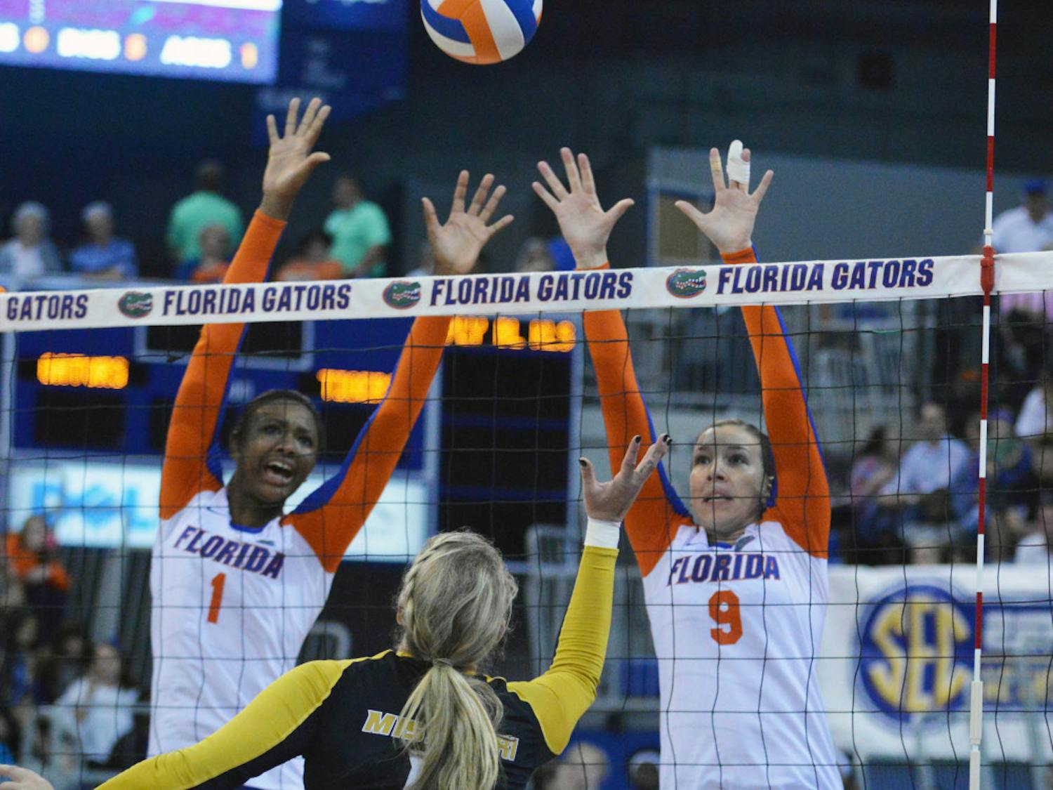 Rhamat Alhassan (1) and Ziva Recek (9) attempt to block a kill attempt by a Missouri player during the Gators' 3-0 win against the Tigers in the O'Connell Center.