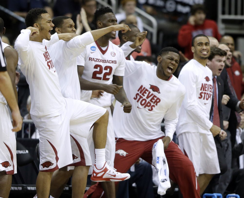 <p>The Arkansas bench celebrates their 56-53 win over Wofford during an NCAA tournament second round college basketball game Friday, March 20, 2015, in Jacksonville, Fla.</p>