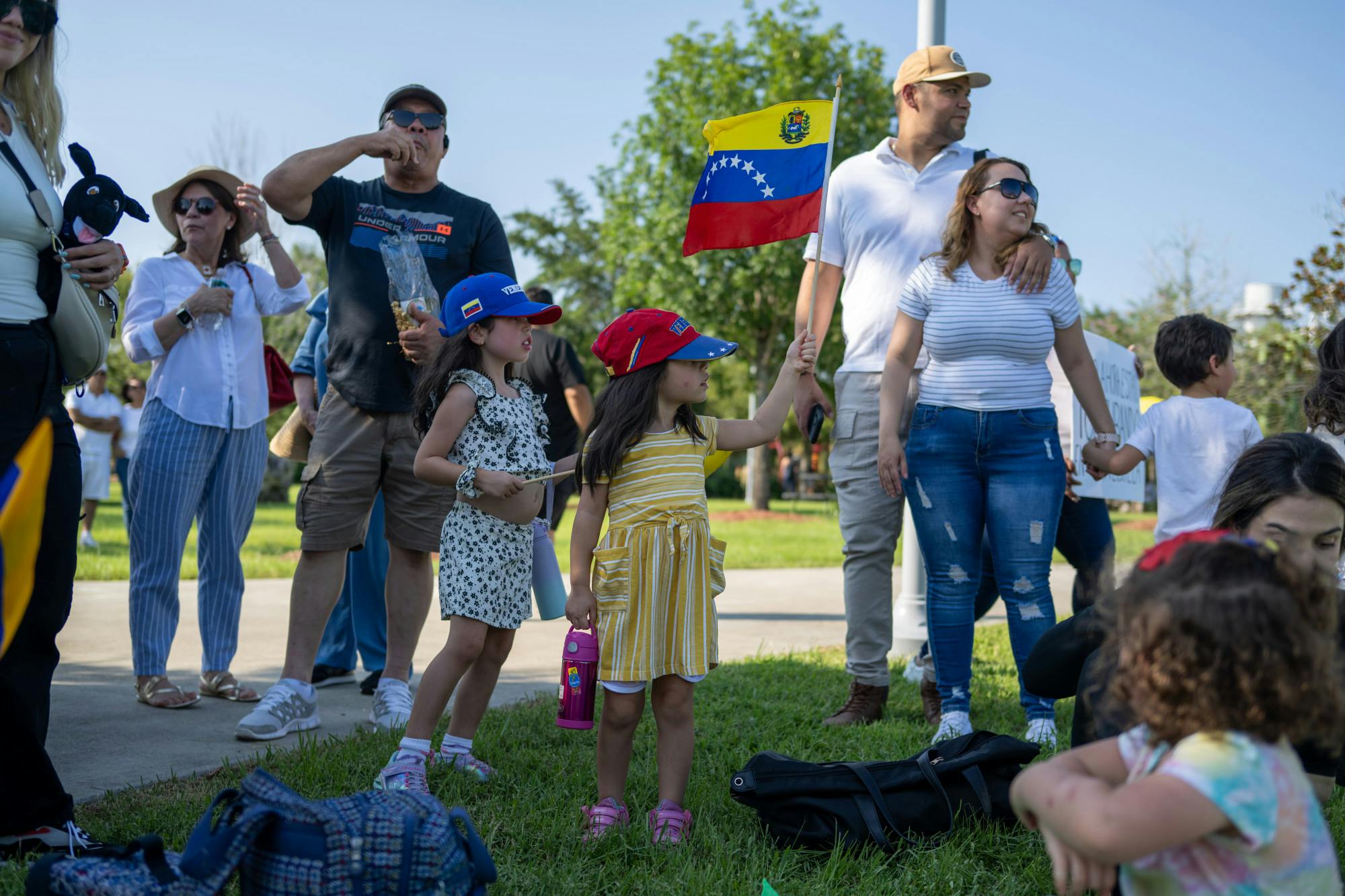 A child waves the Venezuela flag during Saturday's protest at Depot Park.