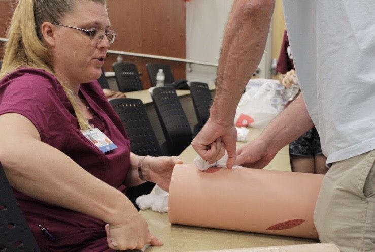 Students practiced stuffing fake bullet hole wounds with gauze Saturday morning. The two-hour-long educational training taught attendees what to do when someone has life-threatening bleeding in an emergency.&nbsp;
