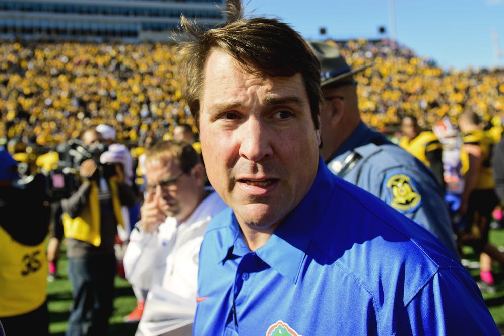 <p>Florida coach Will Muschamp gazes at the Missouri crowd and reflects after the No. 22 Gators' 36-17 loss to the No. 14 Tigers on Oct. 19 in Faurot Field in Columbia, Mo.</p>