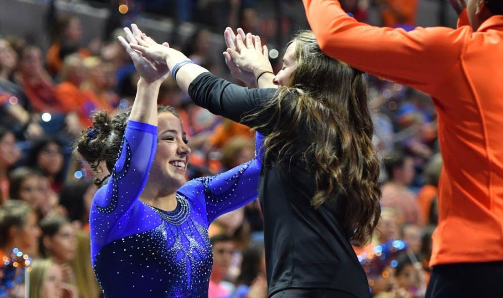 <p>UF gymnast Amelia Hundley celebrates during Florida's win over Kentucky on Jan. 13, 2017, in the O'Connell Center.&nbsp;</p>