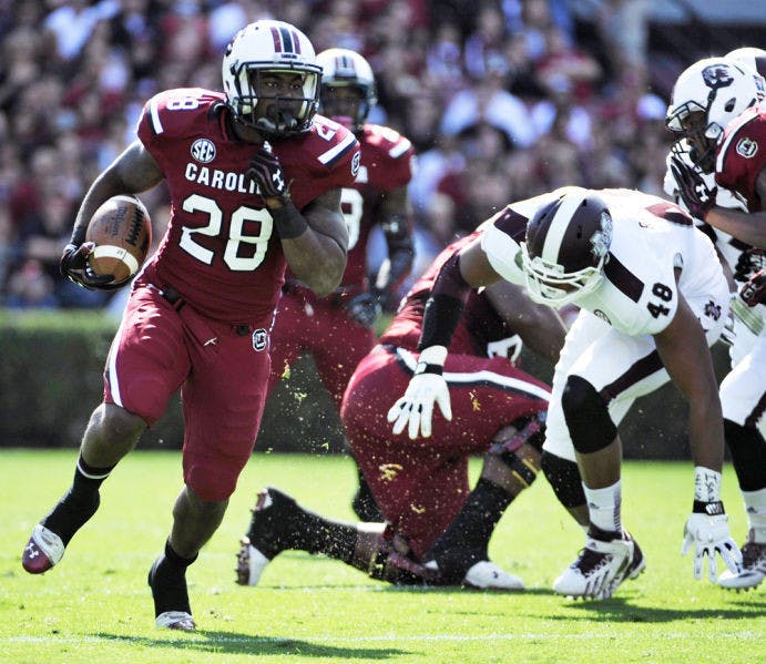 Mike Davis (28) carries the ball during South Carolina’s 34-16 victory against Mississippi State on Nov. 2 in Columbia, S.C. Davis leads the Southeastern Conference in rushing yards per game.