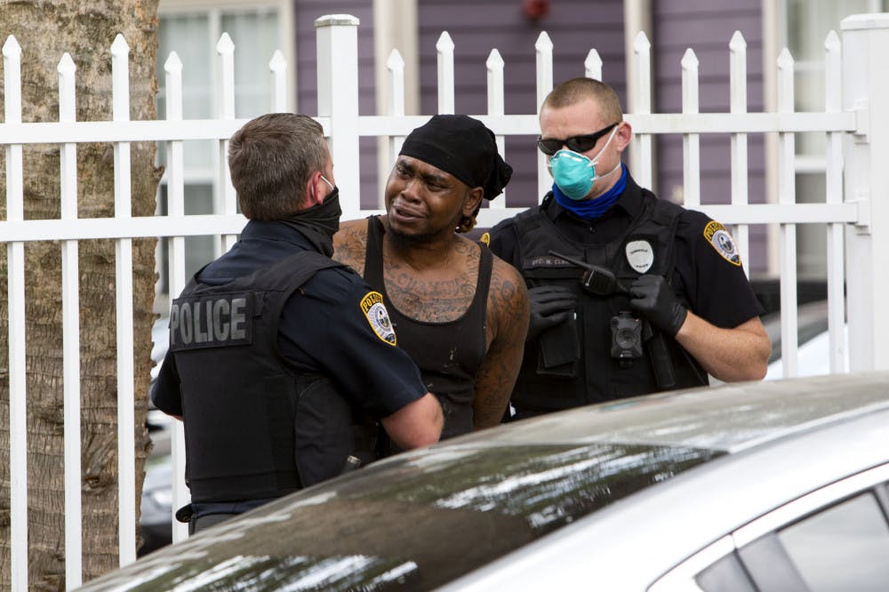 Allen Strawder, 31, is arrested by Gainesville Police Department officers on April 8, 2020, in downtown Gainesville&nbsp;and is accused of battery.&nbsp;Strawder was given a mask to wear in the back of the police vehicle. GPD is following Centers for Disease Control guidelines on interaction with the public, which include recommendations to wear cloth masks, according to spokesperson Sgt. Lisa Scott. There is a stay-at-home order in place in Florida to prevent the spread of COVID-19.