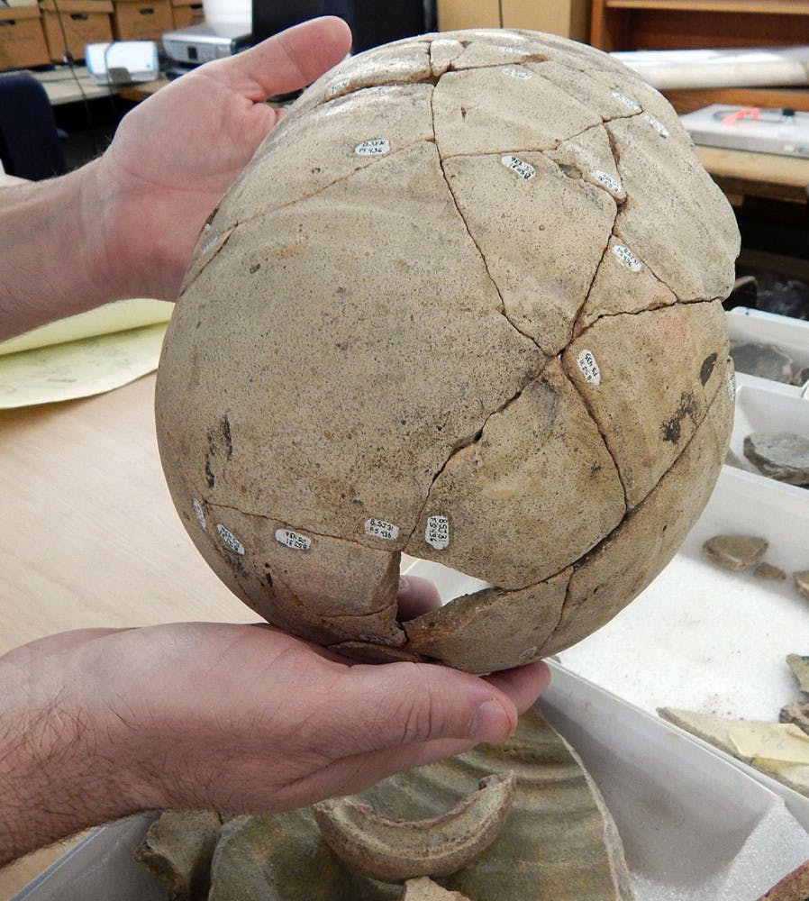 Collections manager Gifford Waters displays a Spanish olive jar reconstructed from artifacts found at the St. Augustine site. 
