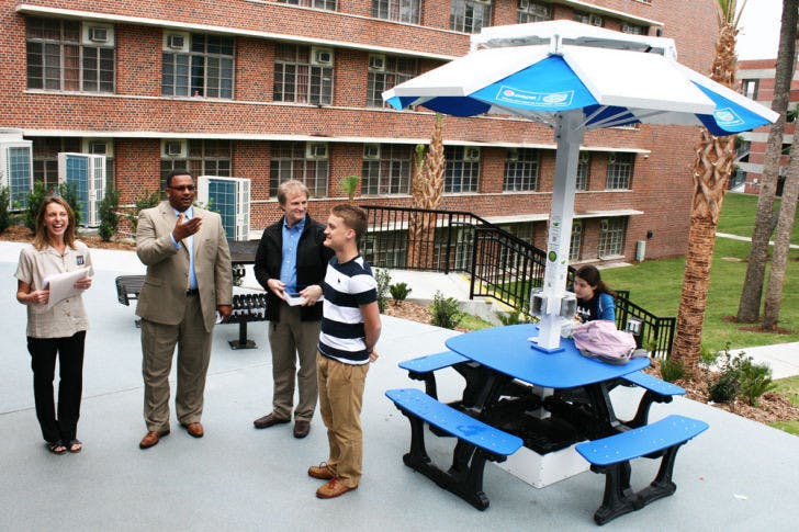 Joshua Pauls, a 19-year-old UF applied physiology and kinesiology sophomore, wins an iPad and has the Solar Dok Station named in his honor at the Rawlings Plaza opening Monday.