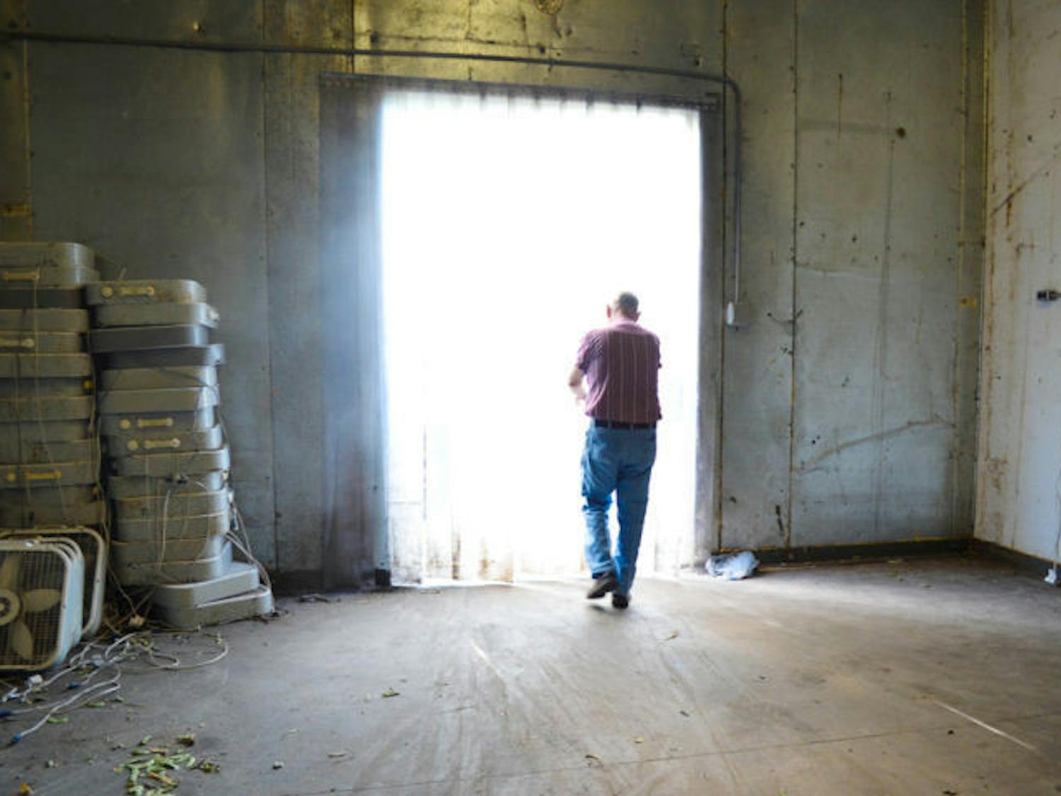 Larry Rogers, 75, exits a refrigerated storage room on his Alachua County farm Friday. Rogers locally sells beans, cucumbers, strawberries, onions, tomatoes and other produce from his farm.
&nbsp;