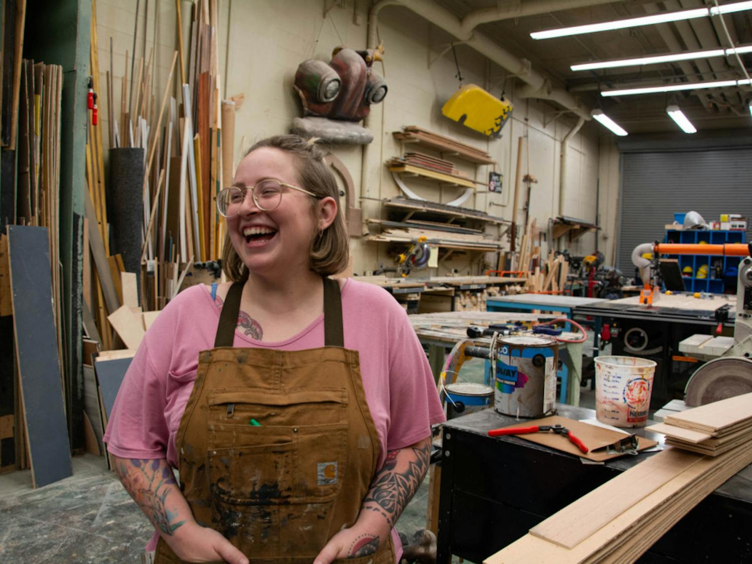 Samantha Lewis, a 24-year-old scene design master's student, in the set shop in the Nadine McGuire Theatre and Dance Pavilion.&nbsp;&nbsp;She designed the entire set herself out of all recyclable material for the play “Hills on Fire.”