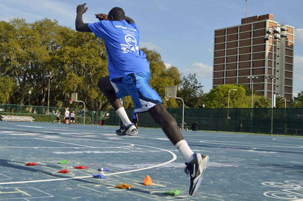 Bunduki “Duke” Ramadan, a 22-year-old UF economics senior, leaps in the air on one of the Broward Outdoor Recreation Complex basketball courts.