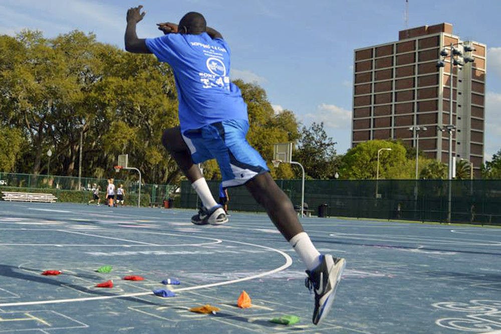 <p>Bunduki “Duke” Ramadan, a 22-year-old UF economics senior, leaps in the air on one of the Broward Outdoor Recreation Complex basketball courts.</p>
