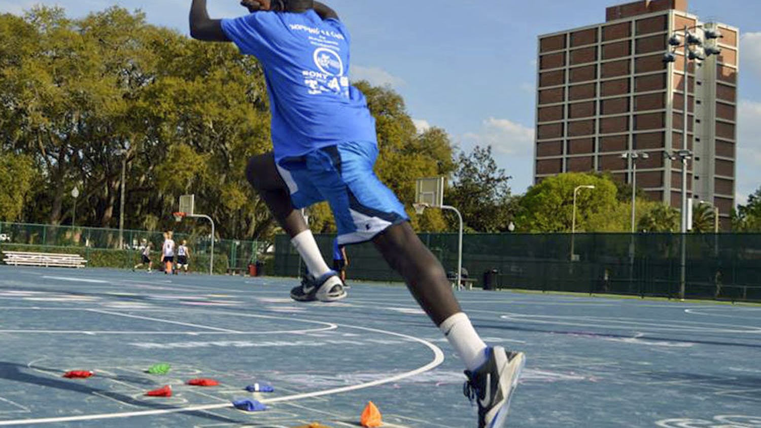 Bunduki “Duke” Ramadan, a 22-year-old UF economics senior, leaps in the air on one of the Broward Outdoor Recreation Complex basketball courts.