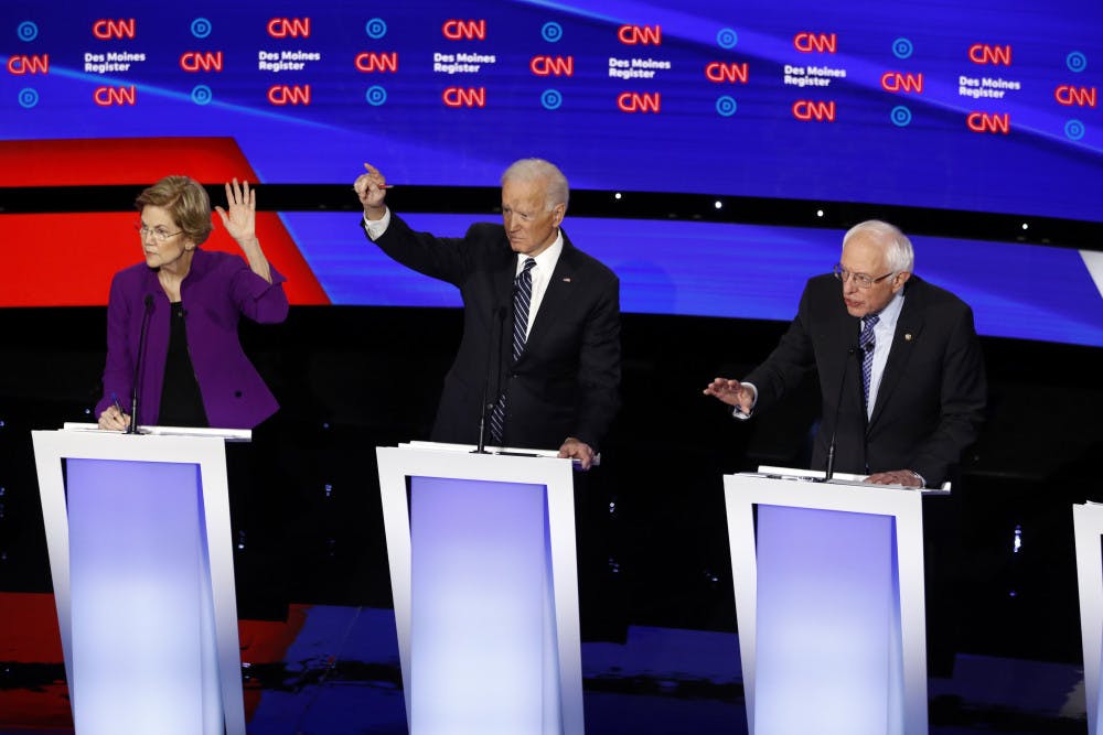 From left, Democratic presidential candidate Sen. Elizabeth Warren, D-Mass., and former Vice President Joe Biden raise their hands as candidate Sen. Bernie Sanders, I-Vt., speaks Tuesday, Jan. 14, 2020, during a Democratic presidential primary debate hosted by CNN and the Des Moines Register in Des Moines, Iowa. (AP Photo/Patrick Semansky)