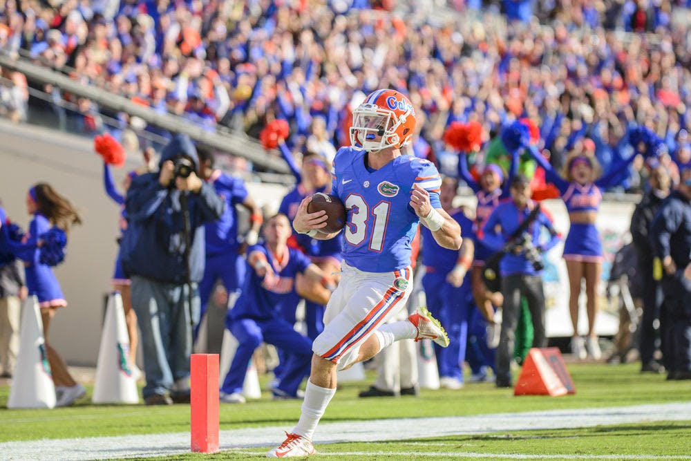 UF wide receiver Mike McNeely runs into the endzone for a touchdown on a fake field goal trick play during Florida's 38-20 win against Georgia on Saturday at EverBank Field in Jacksonville.