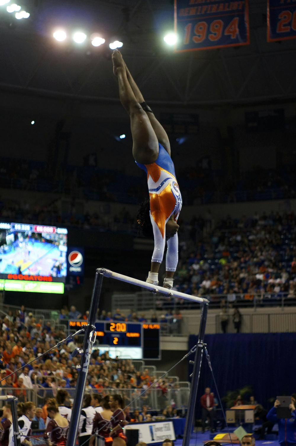 <p>Alicia Boren performs on the uneven parallel bars during Florida's win against Alabama on Jan. 29, 2016, in the O'Connell Center.</p>