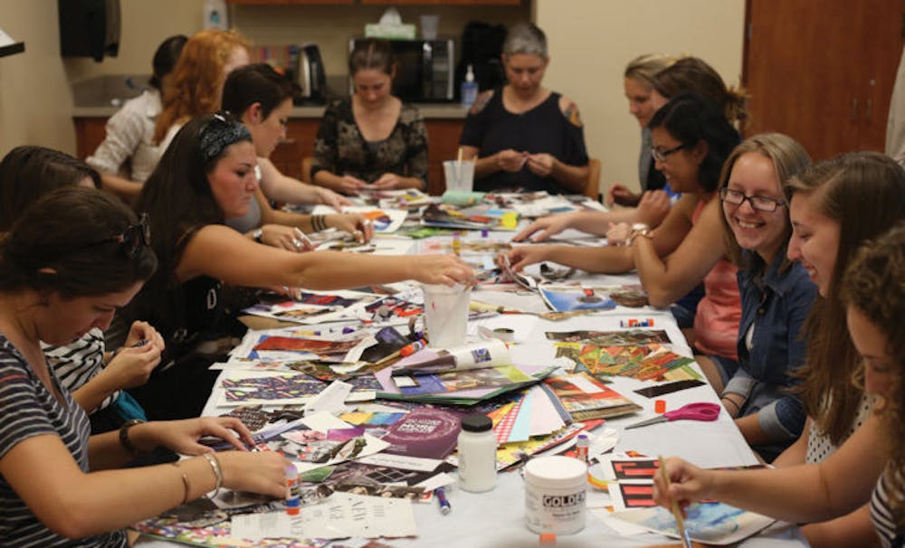 <p>Attendees of the Shands Arts in Medicine Creative for Health workshop cut and paste magazine clips to make abstract collages.</p>