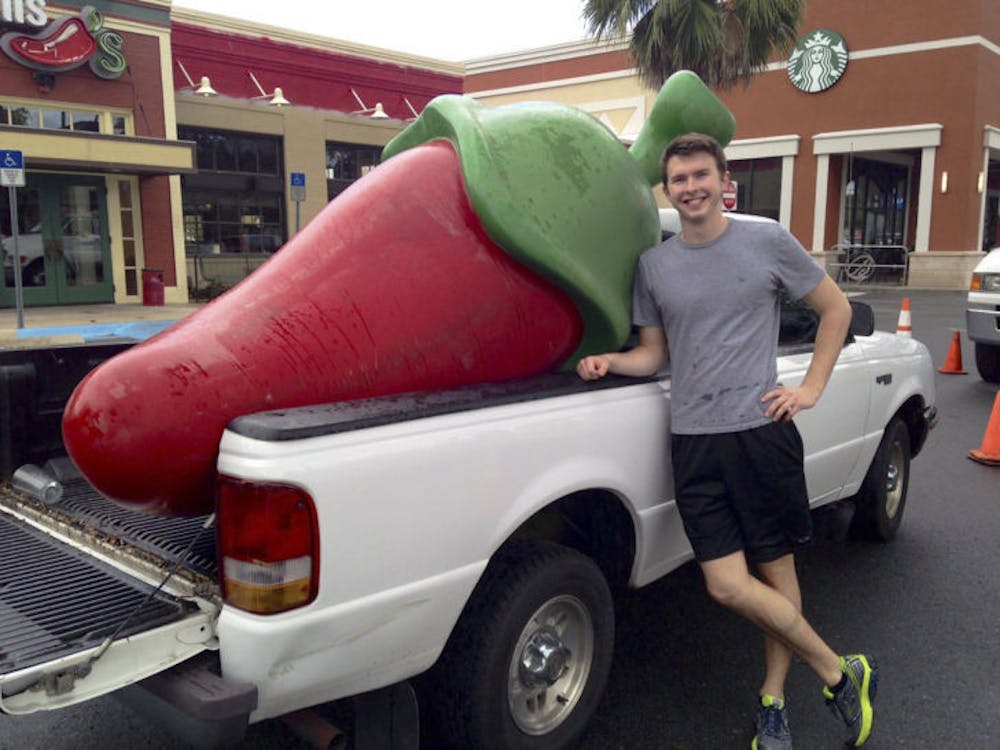 <p class="p1">Daniel Helfrich, a 19-year-old UF classics junior, stands beside his newly bartered red pepper in the parking lot of Chili’s on Archer Road before it went missing.</p>