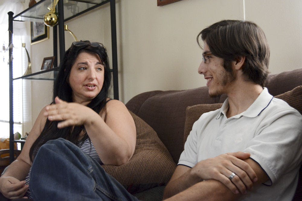 <p>Patricia Garces speaks to her son, Matias Garces, in Spanish in the living room of their mobile home. The Garceses came to the U.S. in 2000 on tourist visas; when their visas expired they became one of the millions of undocumented families living in the country.</p>