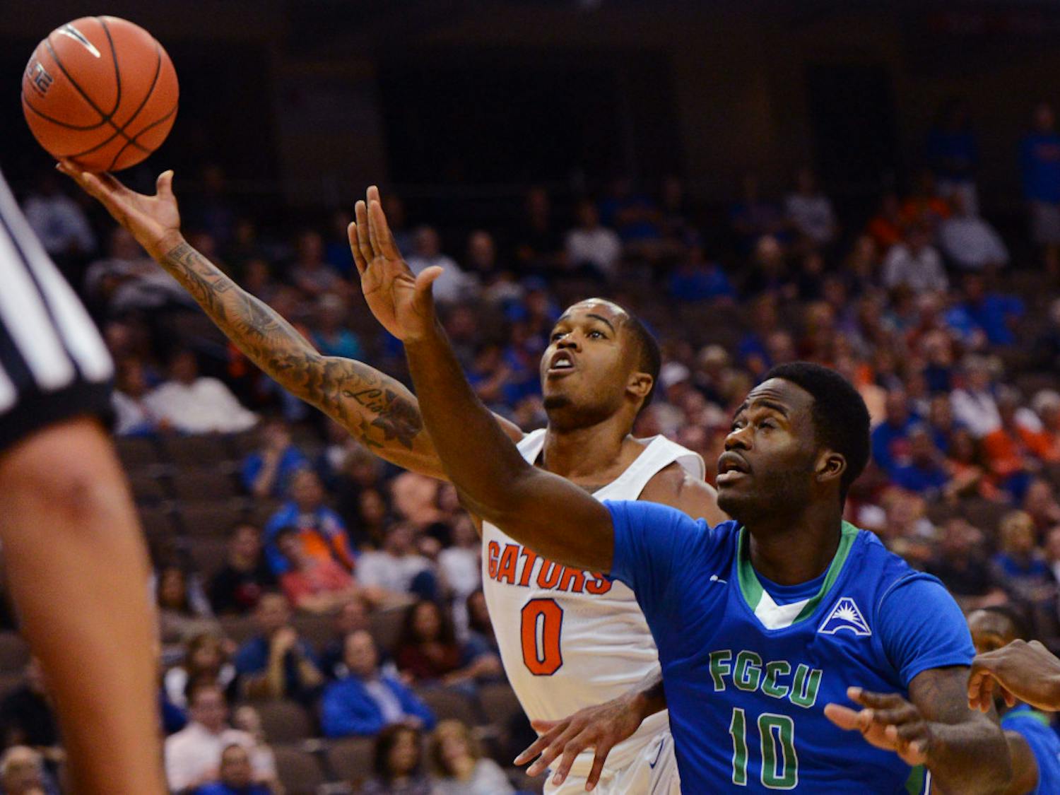 Florida guard Kasey Hill drives to the basket as Florida Gulf Coast forward Kevin Mickle defends during the first half of an NCAA college basketball game, Friday Nov. 11, 2016, in Jacksonville, Fla. (Bob Mack/The Florida Times-Union via AP)