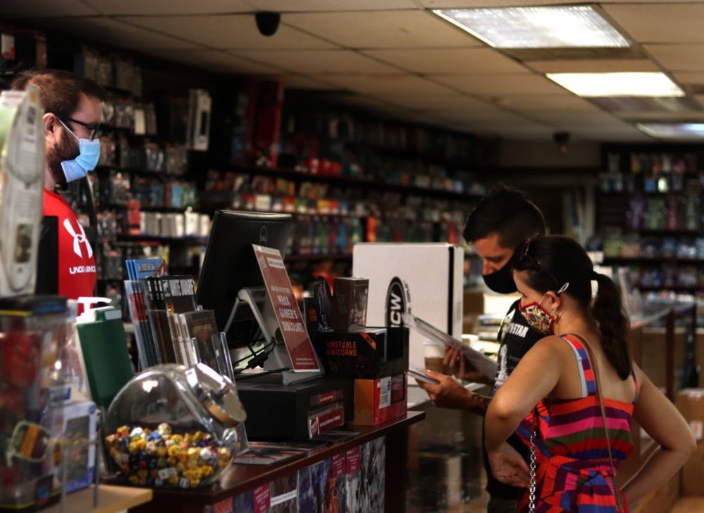 <p><span>Sarah Desforges and Jared Bienlien check out at Mega Gaming &amp; Comics in Gainesville, Fla., on September 5, 2020. </span></p>