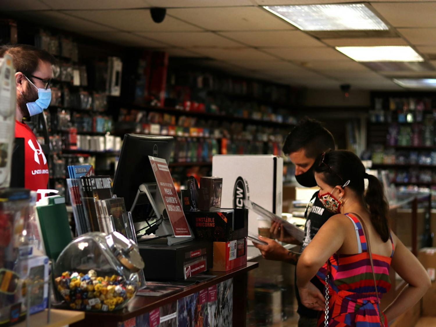 Sarah Desforges and Jared Bienlien check out at Mega Gaming & Comics in Gainesville, Fla., on September 5, 2020.