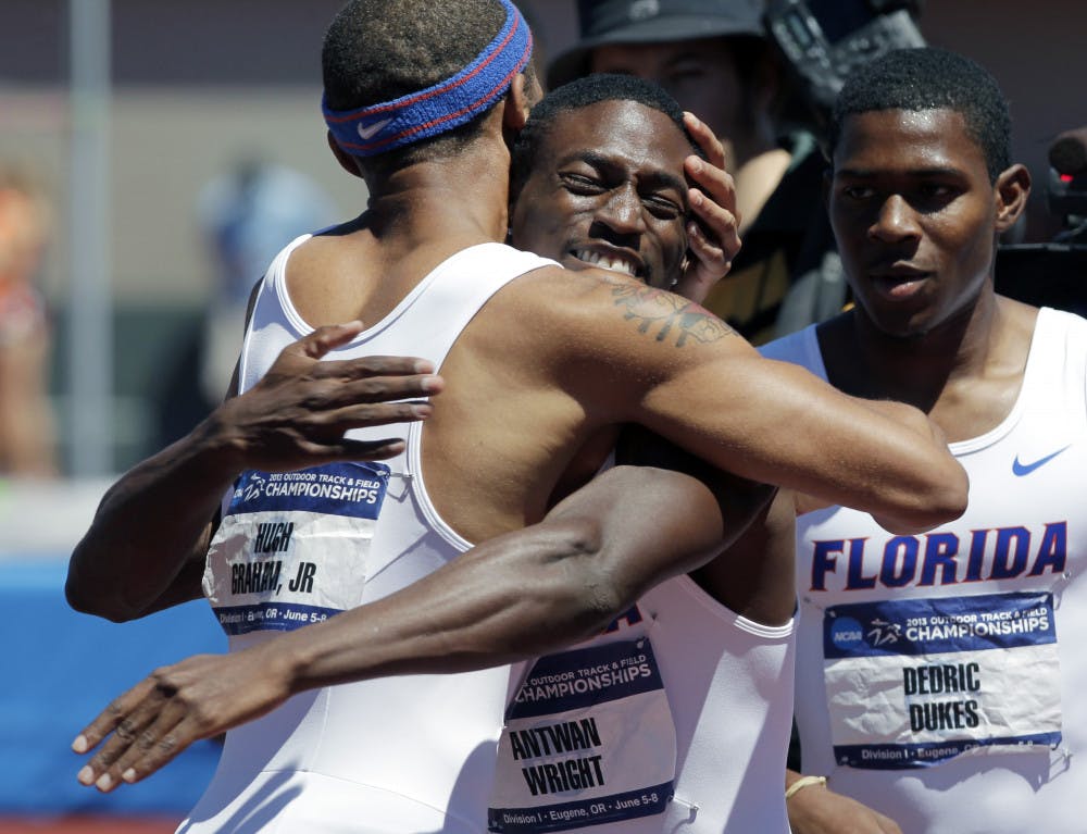 <p>Florida's Hugh Graham Jr., left, hugs Antwan Wright as teammate Dedric Dukes looks on after winning the 4x400-meter race during the NCAA outdoor track and field championships in Eugene, Ore., Saturday, June 8, 2013. Florida tied with Texas A&amp;M for the men's championship.</p>