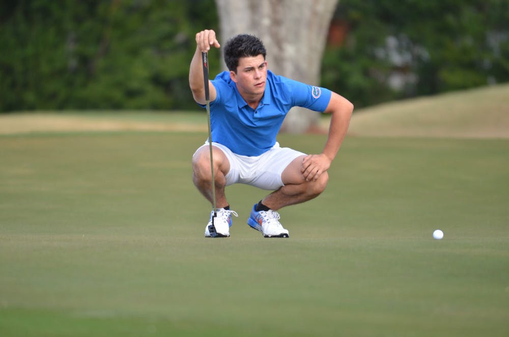 Gordon Neale crouches during round two of the SunTrust Gator Invitational on Feb. 21, 2016, at the Mark Bostick Golf Course.