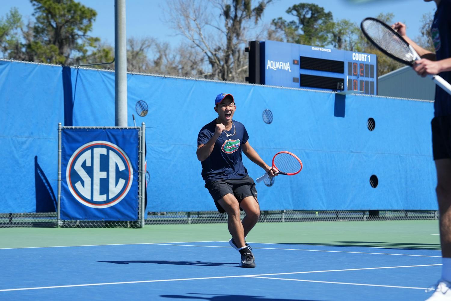 Freshman Jeremy Jin celebrates after winning a point in a doubles match against UCF, Monday, Feb. 19, 2024. 