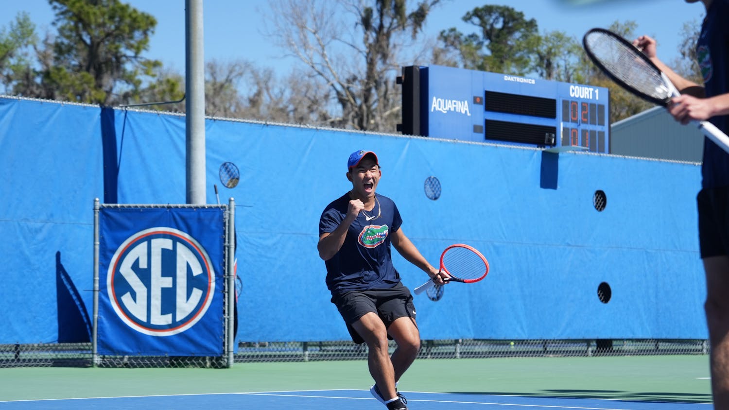 Freshman Jeremy Jin celebrates after winning a point in a doubles match against UCF, Monday, Feb. 19, 2024. 