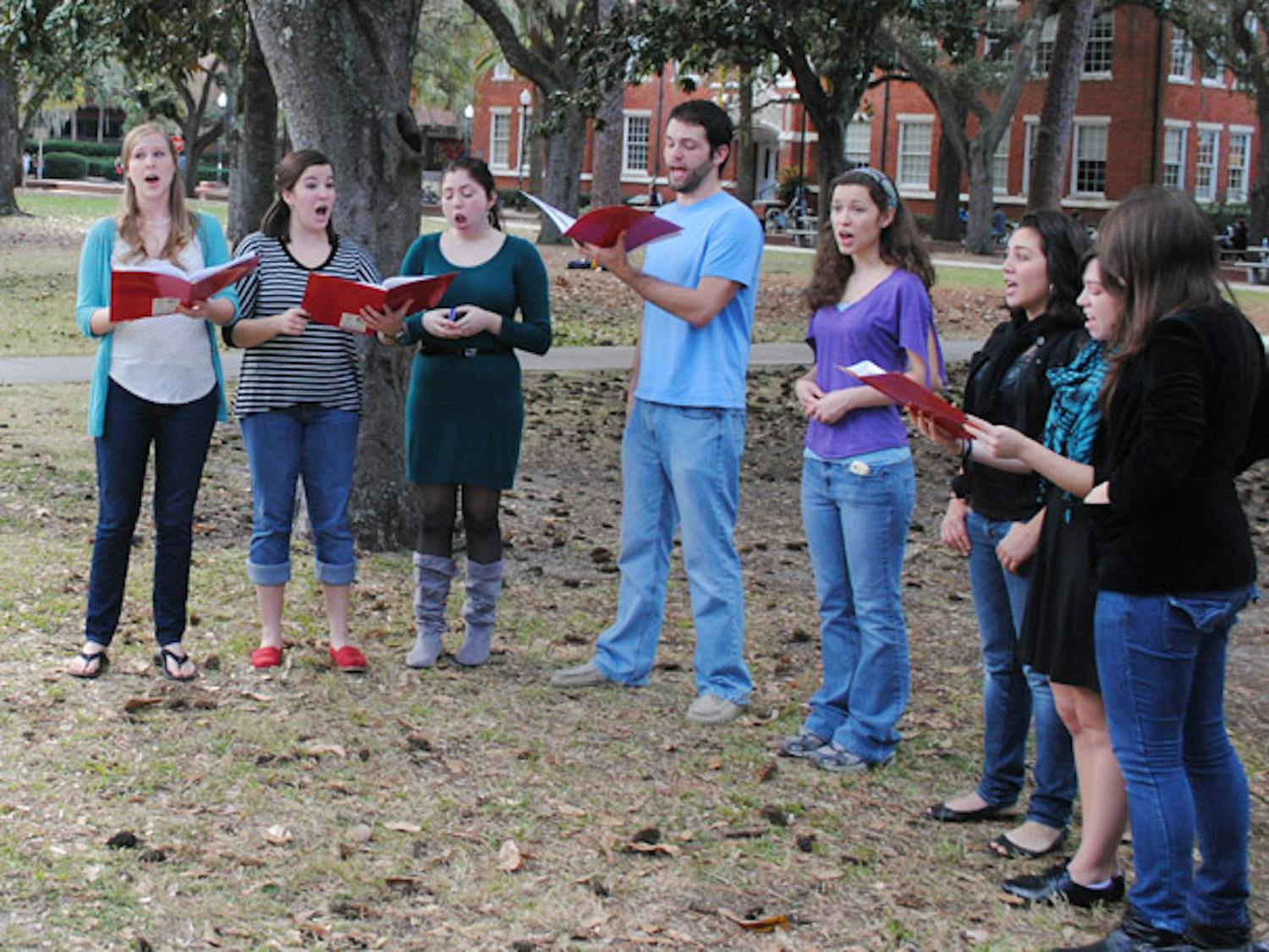 A group of vocal students from UF's College of Fine Arts carol outside Library West on Monday afternoon to showcase their skills and get into the holiday spirit.