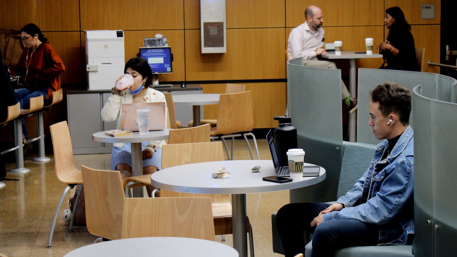 Members of the UF community sit maskless inside of Library West on Friday, March 25. UF announced this week that it no longer expected masks to be worn in its facilities. 