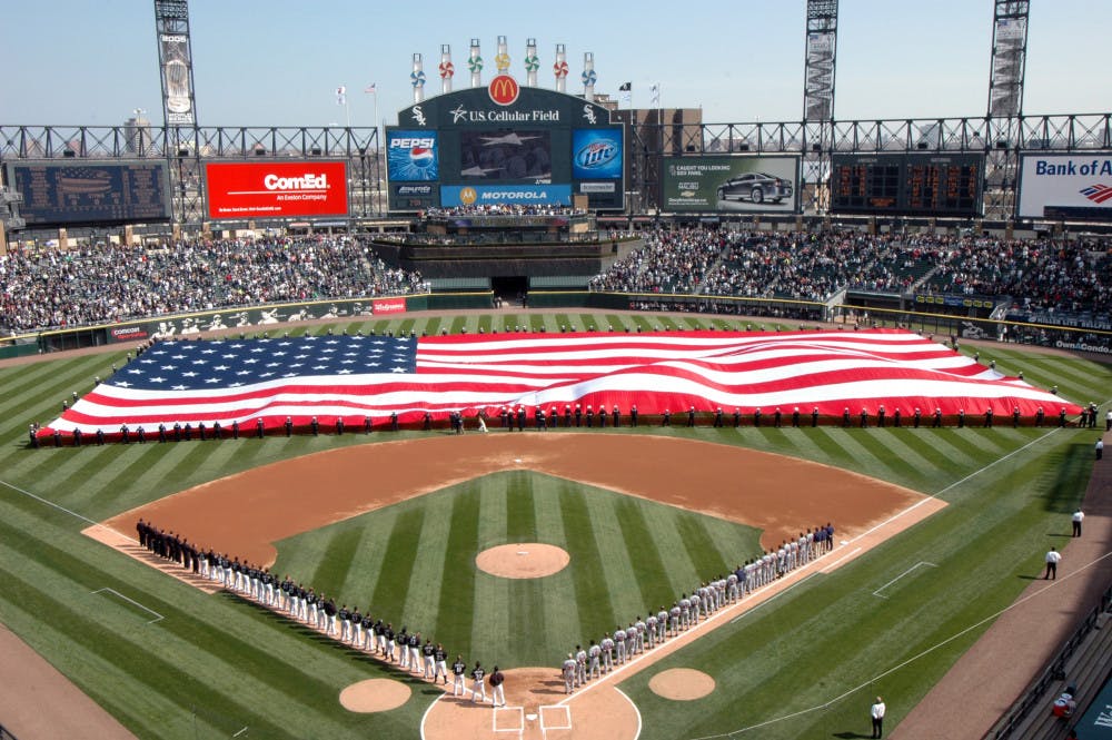 More than 100 U.S. Sailors from Navy Region Midwest, Navy Recruiting Chicago and Naval Station Great Lakes hold an American Flag during the National Anthem at opening day ceremonies for the Chicago White Sox Major League Baseball team at U.S. Cellular Field, Chicago, Ill., April 7, 2008. Great Lakes Sailors have participated in the White Sox opening day for the past six years. (U.S. Navy photo by Scott A. Thornbloom/Released)