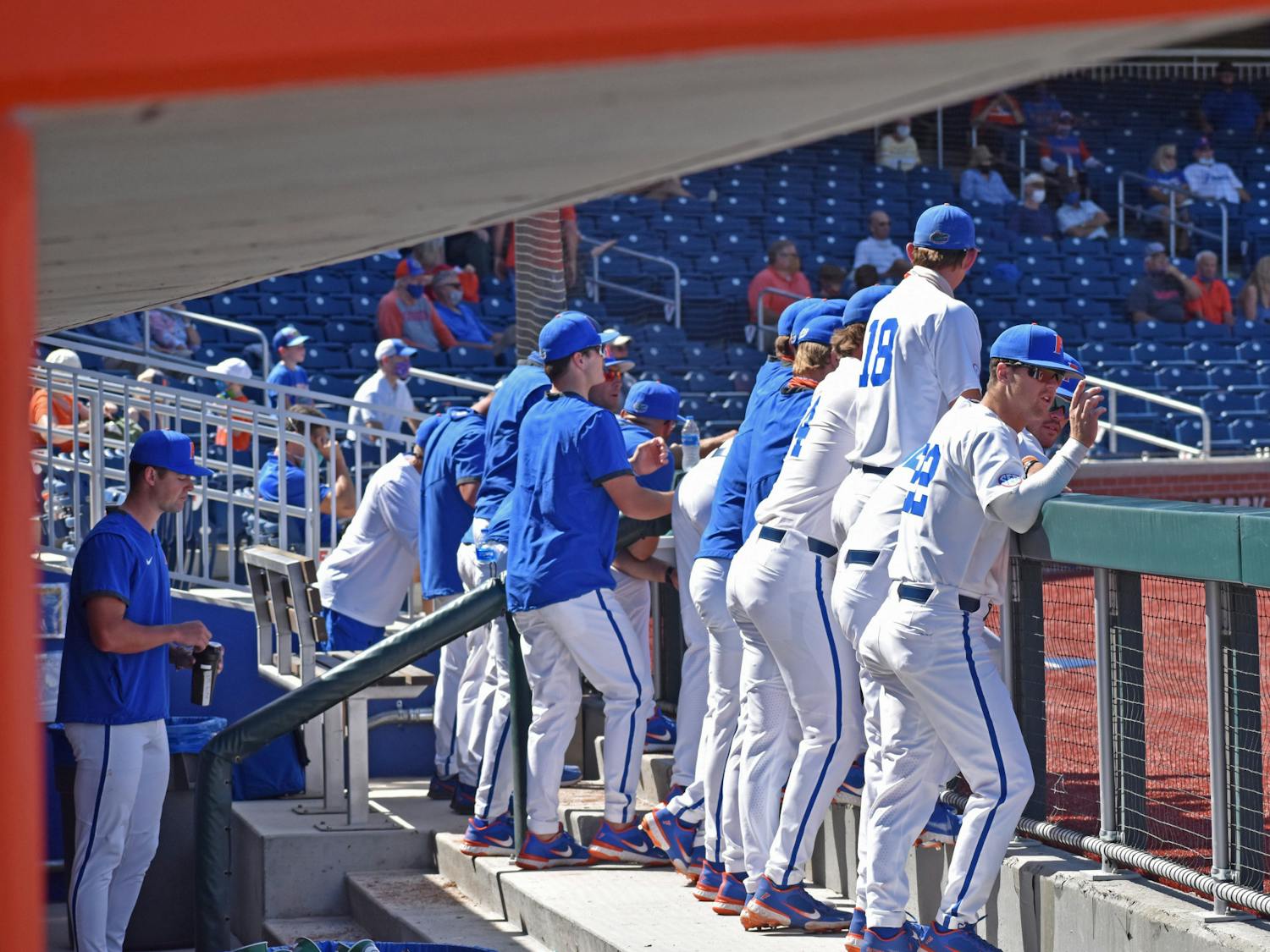 The Florida baseball team stands in the dugout during a game against Jacksonville on March 14, 2021. The Gators host the LSU Tigers for a three-game slate