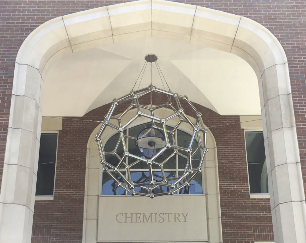 A 650-pound sculpture depicting a form of carbon is suspended by six steel cables over the entrance of Joseph Hernandez Hall, a $66.6 million building that was officially unveiled April 21.