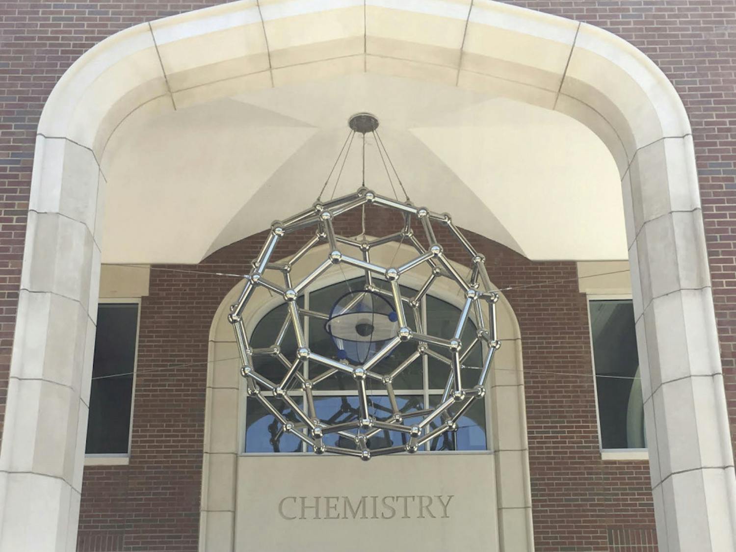 A 650-pound sculpture depicting a form of carbon is suspended by six steel cables over the entrance of Joseph Hernandez Hall, a $66.6 million building that was officially unveiled April 21.