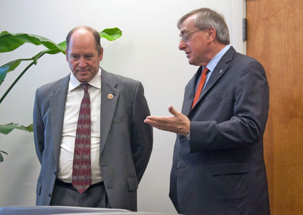 <p><span id="docs-internal-guid-f9c2fc78-d96a-c7c7-82eb-54c4e9c50b22"><span>Congressman Ted Yoho and UF President Kent Fuchs discuss the process of the National Science Foundation conference before it begins. Fuchs invited Yoho to visit UF on Friday.</span></span></p>