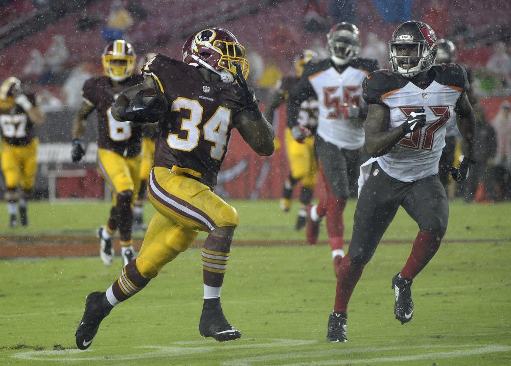 <p>Washington Redskins running back Mack Brown (34) runs away from Tampa Bay Buccaneers strong safety Keith Tandy (37) on a 60-yard touchdown run during the second quarter of an NFL preseason football game Wednesday, Aug. 31, 2016, in Tampa, Fla. (AP Photo/Phelan M. Ebenhack)</p>