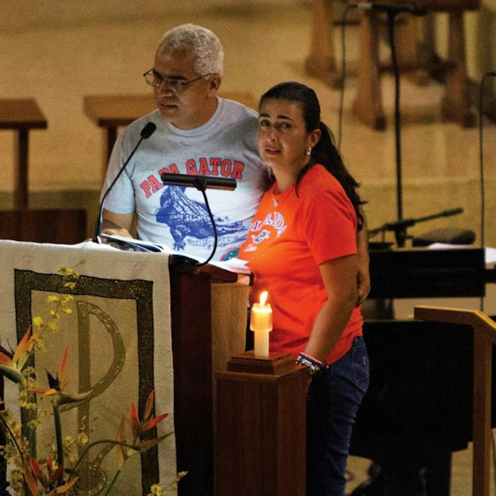 <p>Carlos and Claudia Aguilar speak at St. Augustine Church on Monday night at a memorial for their son, Christian Aguilar, whose remains were discovered Friday.</p>