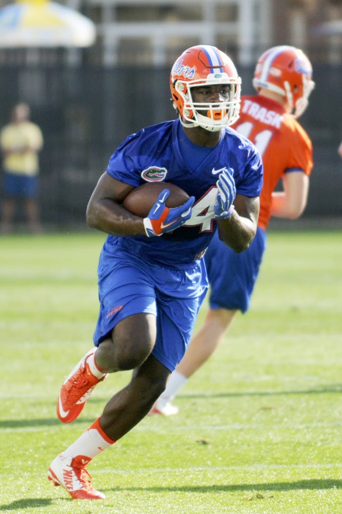 Mark Thompson carries the ball during practice on March 9, 2016, at the Sanders Practice Fields.