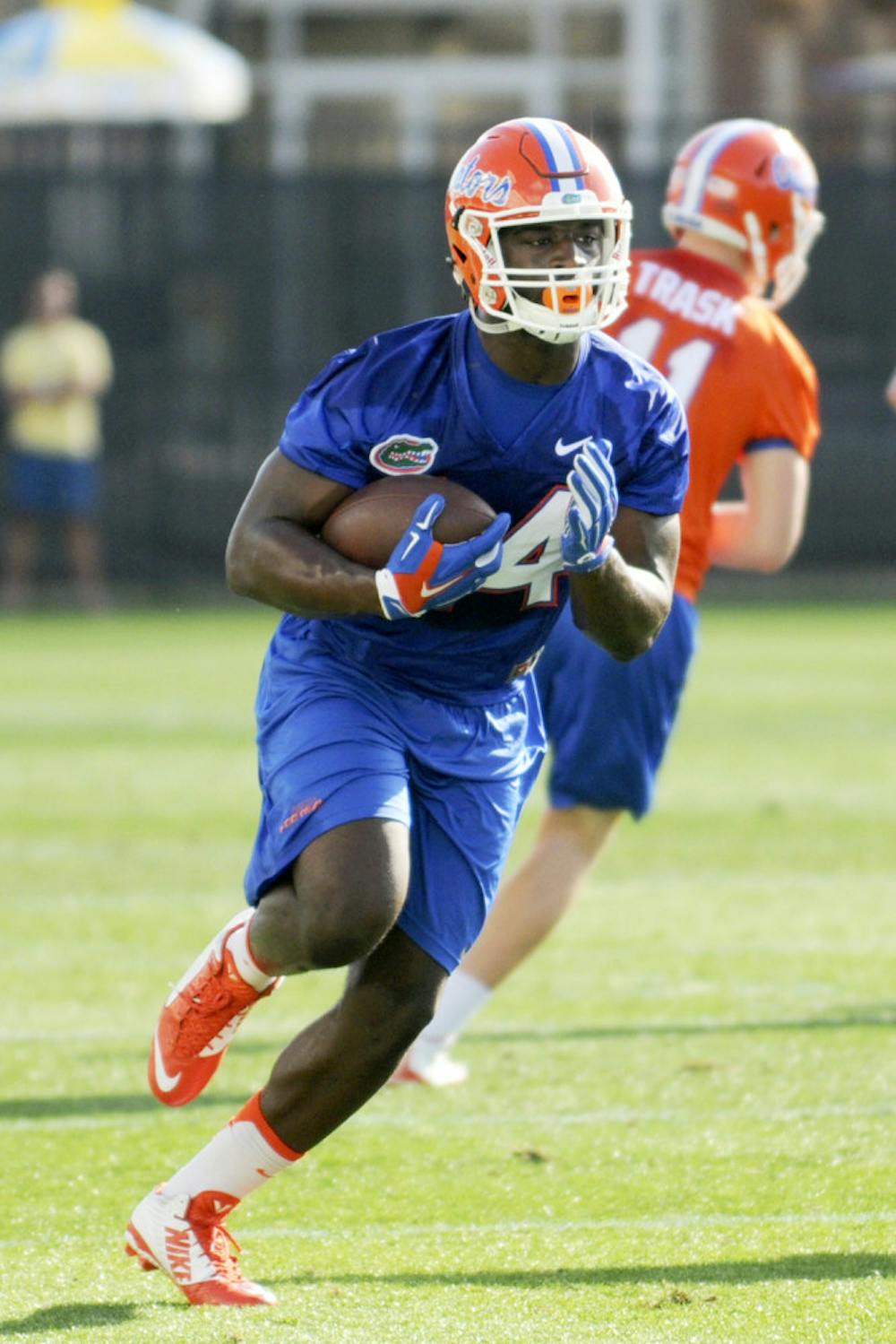 <p>Mark Thompson carries the ball during practice on March 9, 2016, at the Sanders Practice Fields.</p>