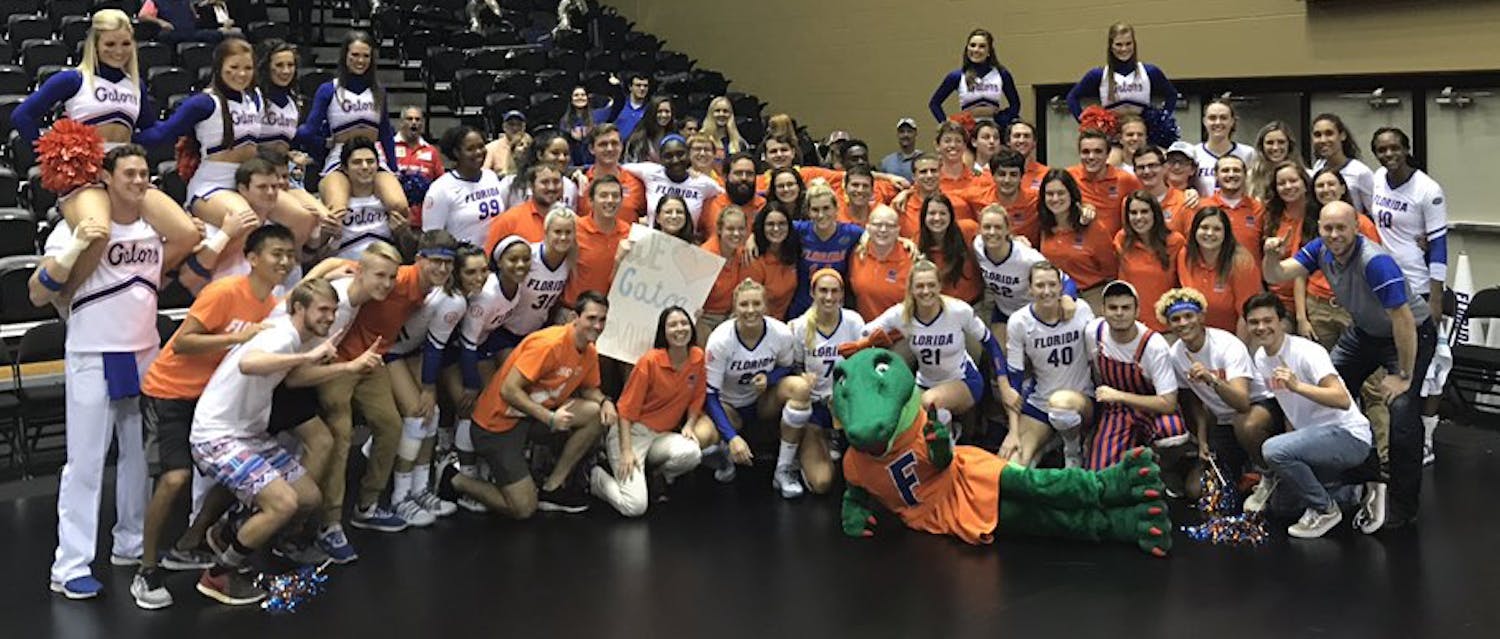 The UF volleyball team celebrates its sweep of FGCU (25-17, 25-13, 25-17) in the second round of the NCAA Tournament with some fans and the Florida band.&nbsp;